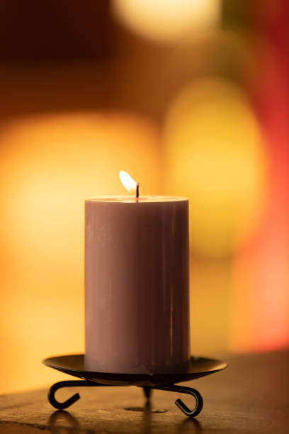 istock Candle in colorful background 1165218380