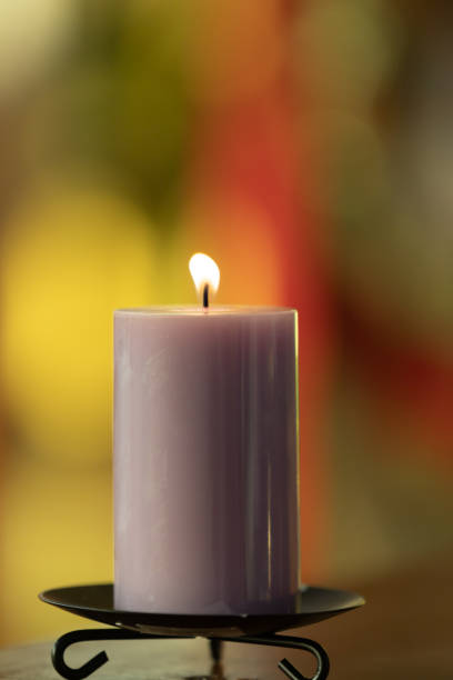 istock Candle in colorful background 1165218381