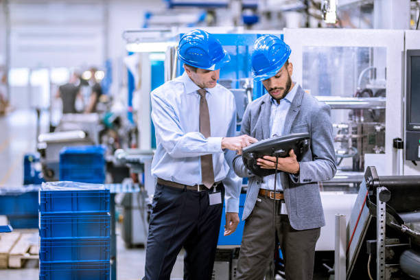 istock Shift manager talking to engineer in a factory 1165220566