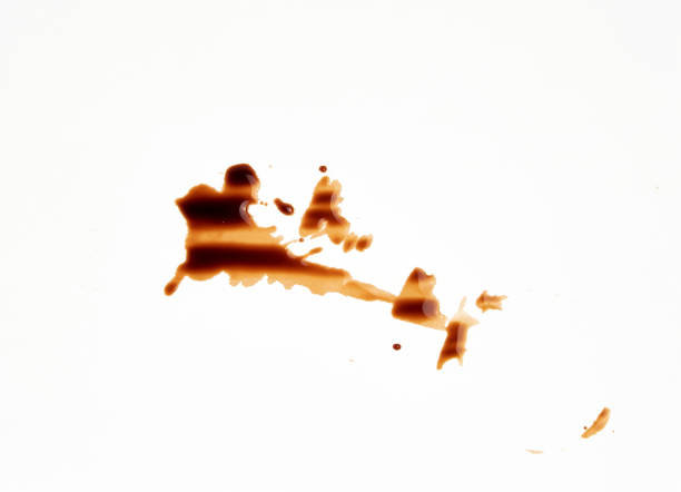 istock spilled black coffee on white paper, abstract stains 1165221285