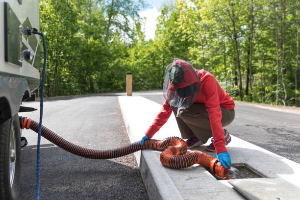istock Woman Emptying RV Sewer After Camping 1165222914