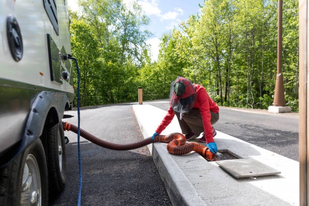 istock Woman Emptying RV Sewer After Camping 1165222953