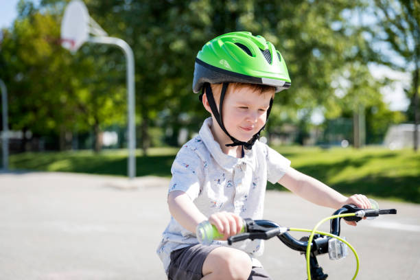 istock Little Redhead Boy Riding his Bicycle in Schoolyard 1165223137