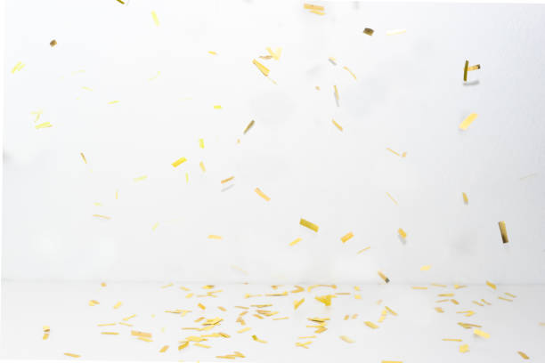 Confetti party on gold background.