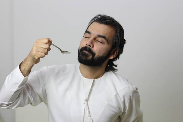istock Arab Man Eating With Spoon Enjoying The Taste With Closed Eyes 1165226766