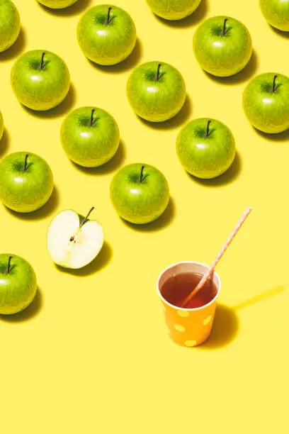 Photo of Green apple juice flat lay on yellow background