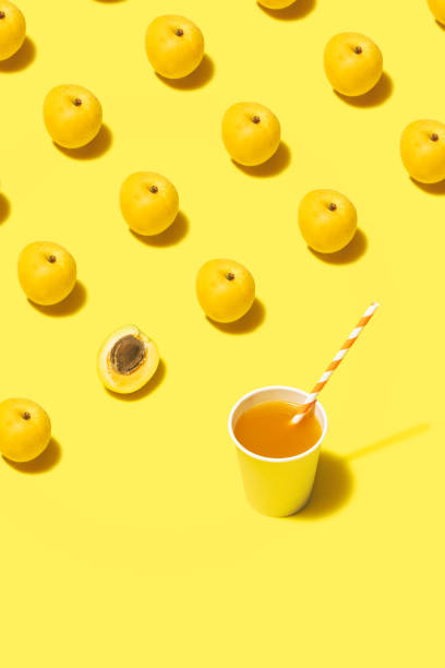 istock Apricot juice flat lay on yellow background 1165233408