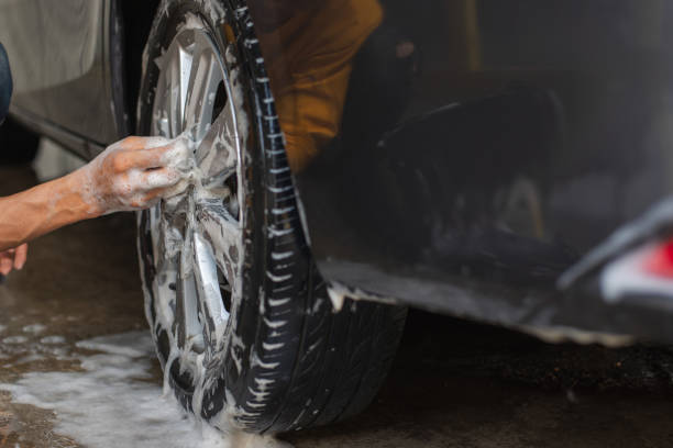 istock Car washing. cleaning car worker using high pressure water. 1165234783