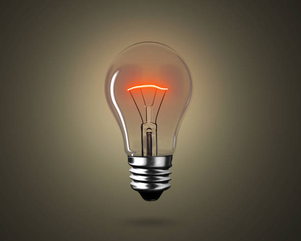 istock Lighting bulb lamp illuminating dark black background, 3D rendering 1165234789