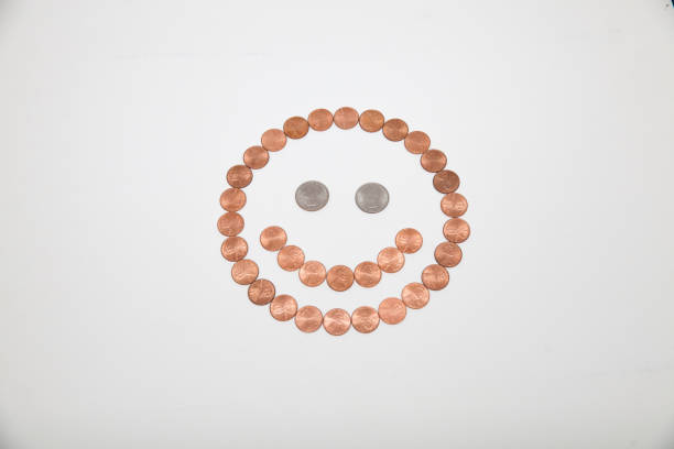 Smiley face made out of coins stock photo
