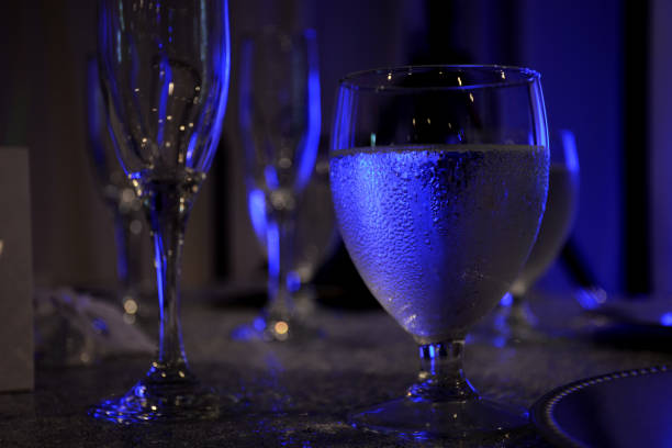 istock Luxury glasses on a Table with a beautiful blue light reflecting on 1165238404