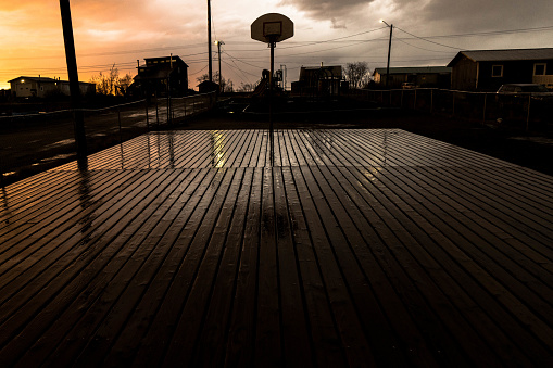 A basketball court is covered in water after rain in western Alaska.