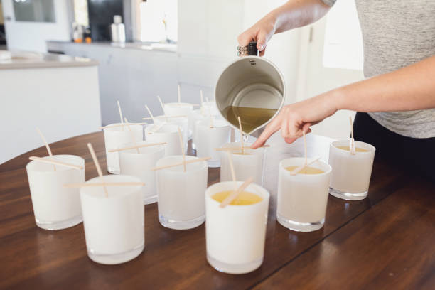 Pouring Wax Into Candle Jars - Candle Making Process stock photo
