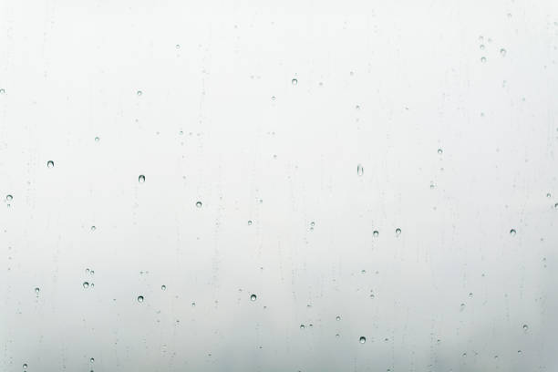 istock Water drops on glass window in grey shades 1165241737