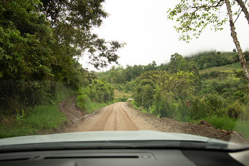 A car drives through a roadway to the rainforest in Peru (Marginal roadway)
