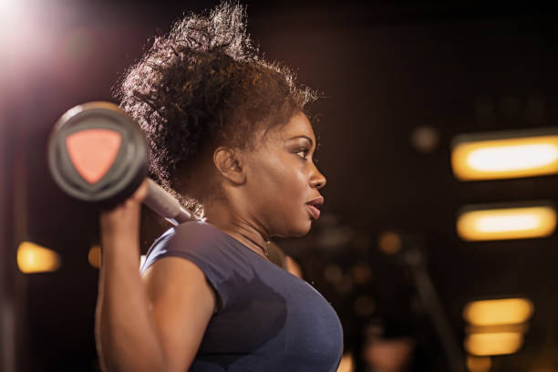 istock Beautiful Middle Aged Black Female Athlete working out in Gym Setting 1165246585