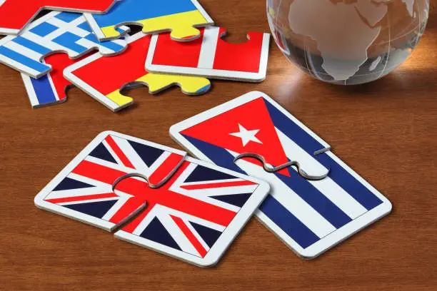 puzzle with the national flag of England and Cuba on wooden table