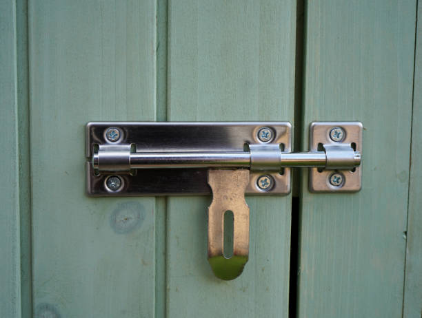 Silver door bolt on a wooden door Silver door bolt on a wooden door latch stock pictures, royalty-free photos & images