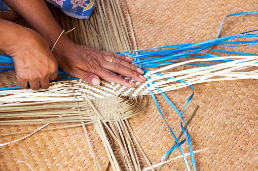 an artisan making a basket in the image
