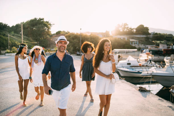 istock Tourists walking on street during vacations 1165250110