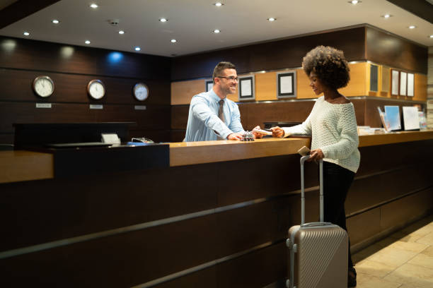 istock Businesswoman paying at hotel reception 1165251278