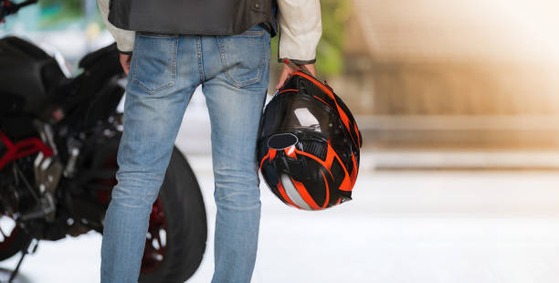 istock Man in blue jean holding a helmet 1165251436