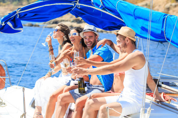 istock Friends having champagne party on yacht 1165251457