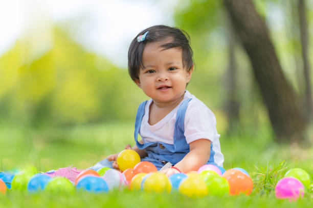 istock Happy small child and colored balls in the park 1165251618