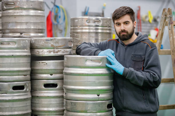 istock Worker taking a break, leaning on aluminum barrels 1165252561