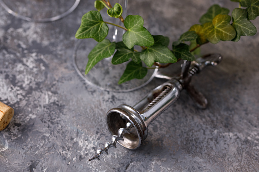 Exquisite vintage corkscrew for wine on a textural background. Copy space. Place for your text. Close-up.