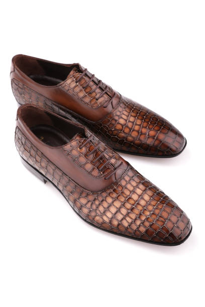 Close up shots of leather shoes from crocodile skin