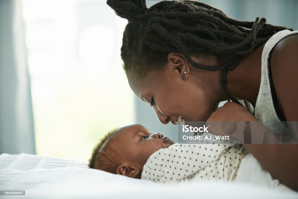 You're just the cutest baby I've ever seen Shot of a mother and her newborn baby at home Mother Stock Photo