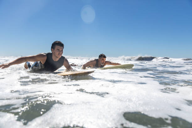 istock Father and son surf on the beach in California 1165255698