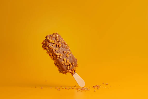 istock chocolate ice cream popsicle on yellow background 1165255852