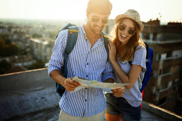 istock Happy couple on vacation sightseeing city with map 1165257026
