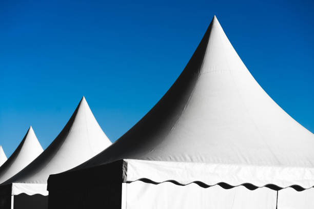 istock Pointed tents against the blue sky 1165258216