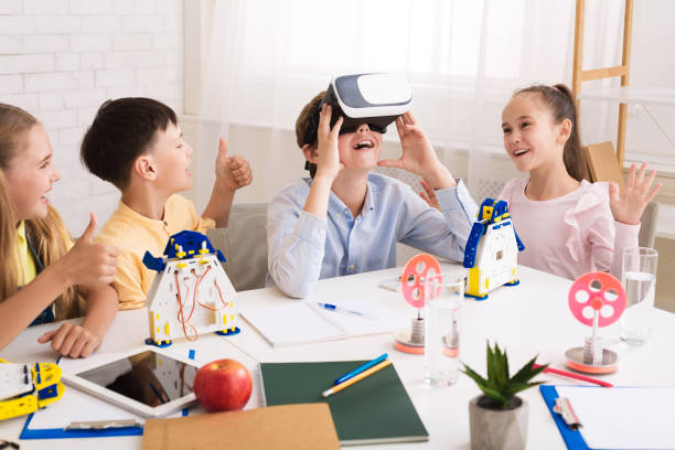 istock Children having fun with vr goggles in classroom 1165260367