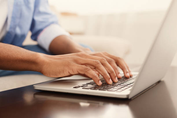 Male hands typing text or programming code on laptop Working at laptop pc. Close up image of male hands typing text or programming code in computer at home form stock pictures, royalty-free photos & images