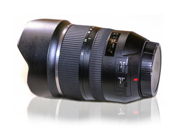 istock Wide angle DSLR lens 15-30mm with lens cap in white background 1165260390