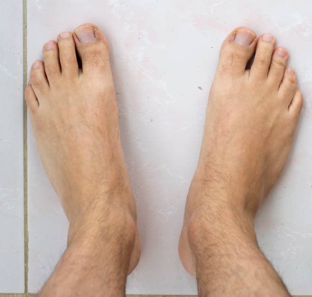 Selective focus. Male feet on white background.