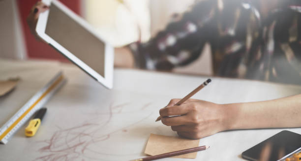 istock Fashion designer sketching new collection 1165260583