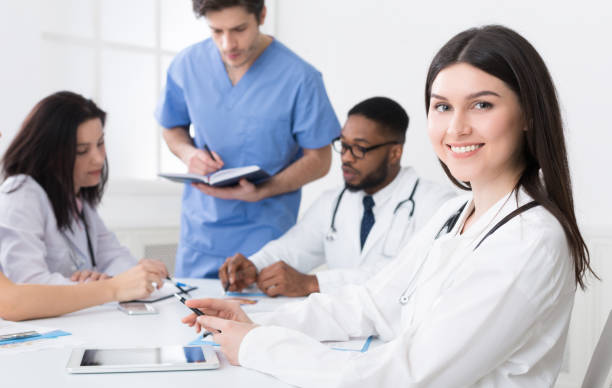 istock Medical conference. Practitioner at meeting looking at camera 1165260594