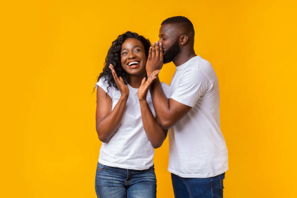 istock Black guy whispering gossips to his girlfriend 1165260650