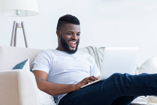 istock African-american guy playing video game on laptop 1165260804