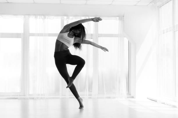 istock Young Woman Training Contemp In Modern Dance Studio. Black And W 1165261079
