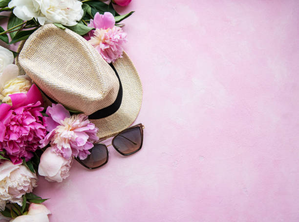 istock Pink peonies and hat on a pink concrete background 1165262030
