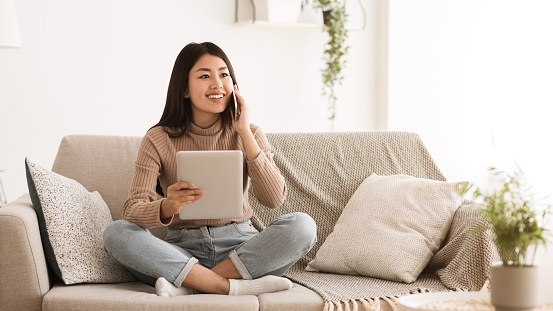 Girl Calling Friend, Using Digital Tablet at Home