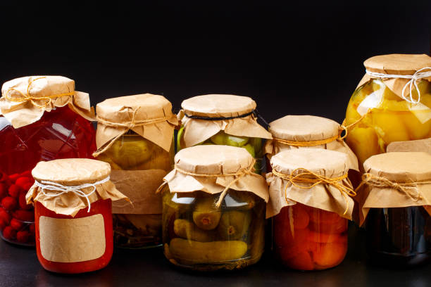 istock glass bottle with preserved food on black background - Image 1165263123