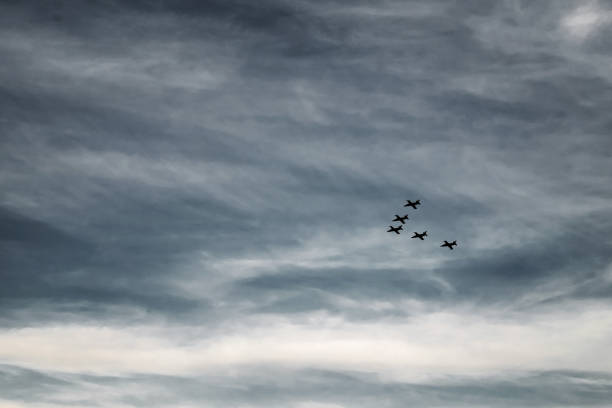 istock fighters are flying in the sky 1165263229