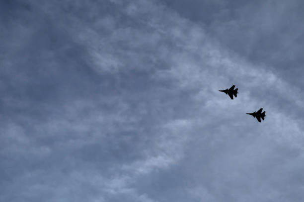 istock fighters are flying in the sky 1165263252